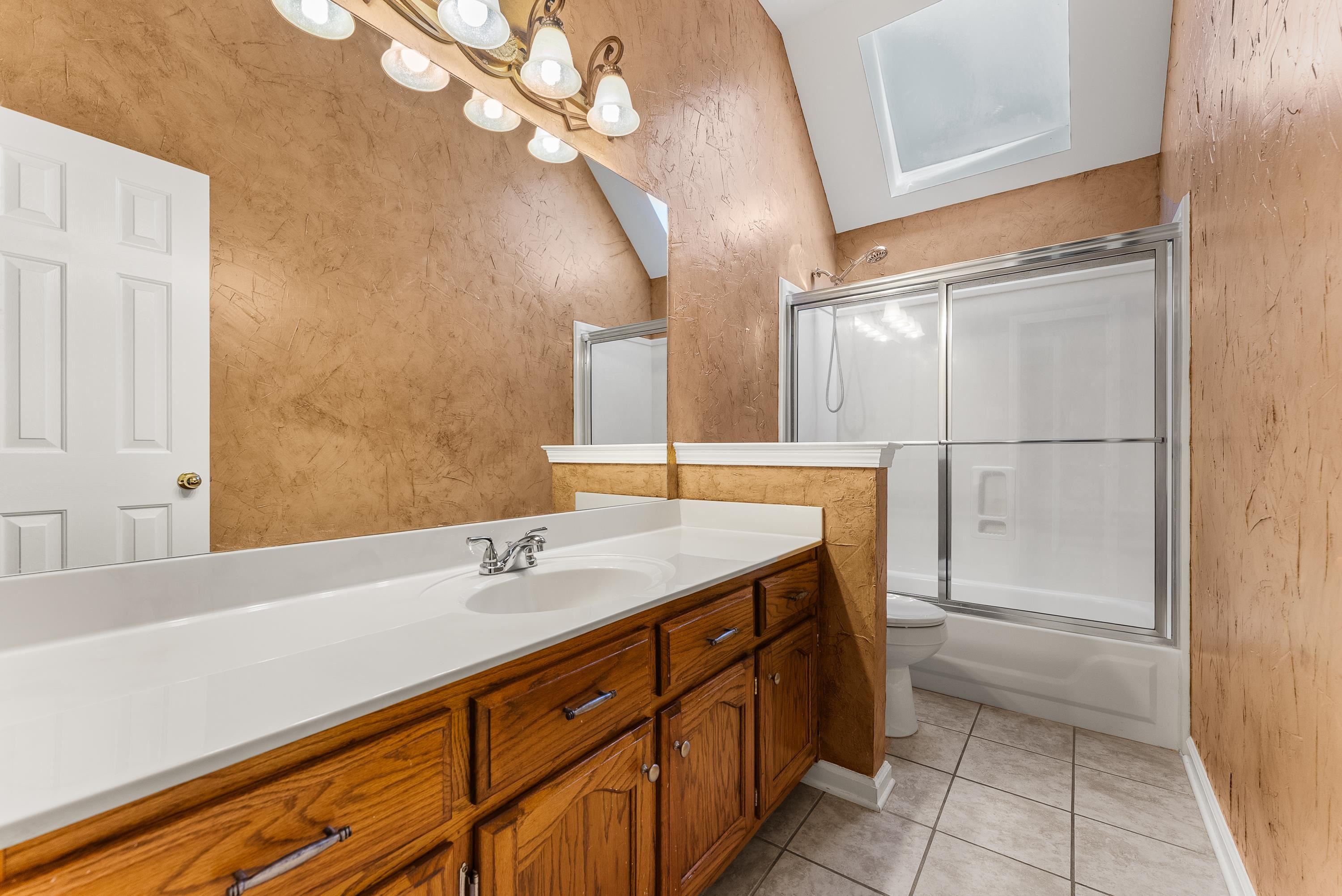 978 Sugar Lane Collierville, TN 38017 - Photo 12 of 14 a bathroom with a sink a vanity and a mirror