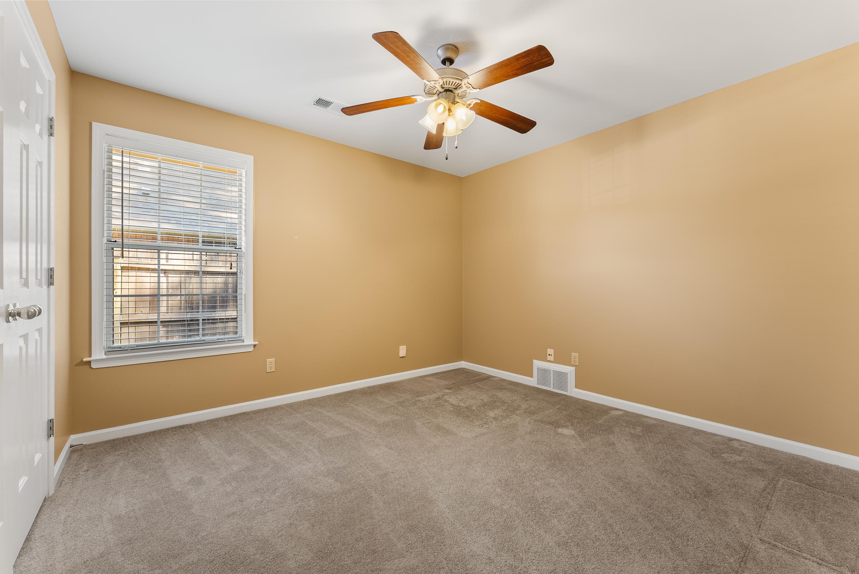 978 Sugar Lane Collierville, TN 38017 - Photo 10 of 14 an empty room with window and ceiling fan