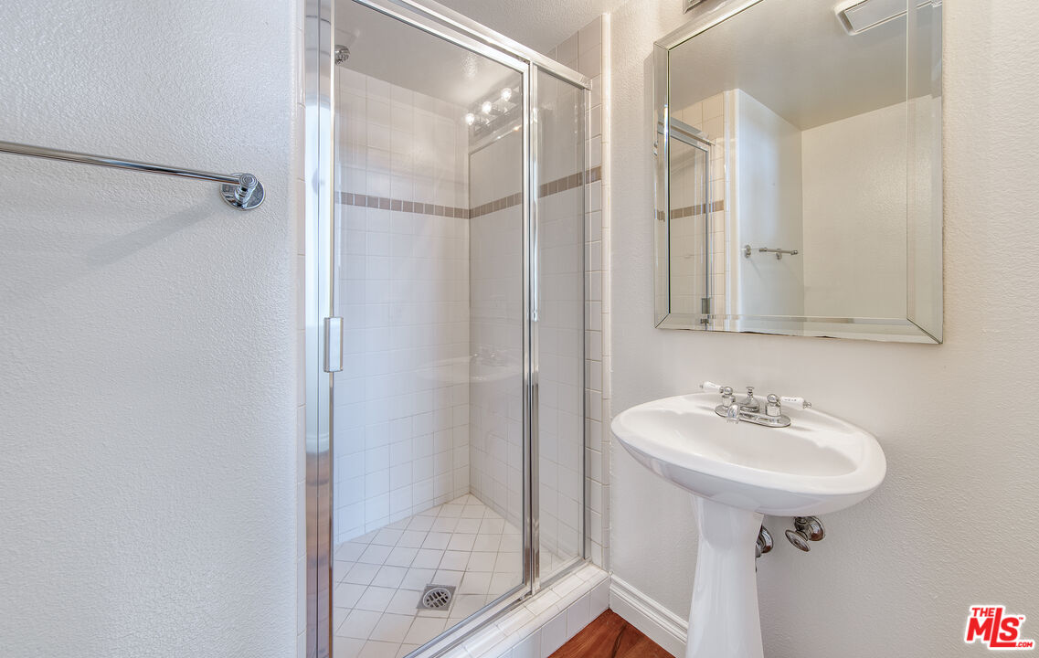 2333 Oak Street, Unit 2 Santa Monica, CA 90405 - Photo 13 of 30 a bathroom with a sink a mirror and a shower