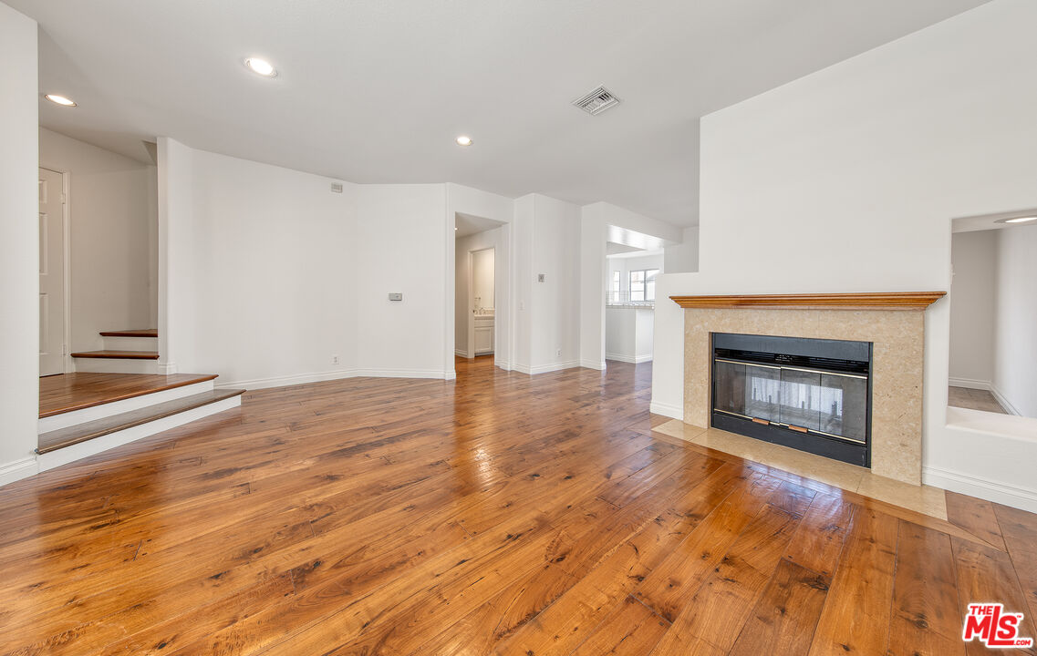 2333 Oak Street, Unit 2 Santa Monica, CA 90405 - Photo 22 of 30 a view of an empty room with wooden floor fireplace and a window