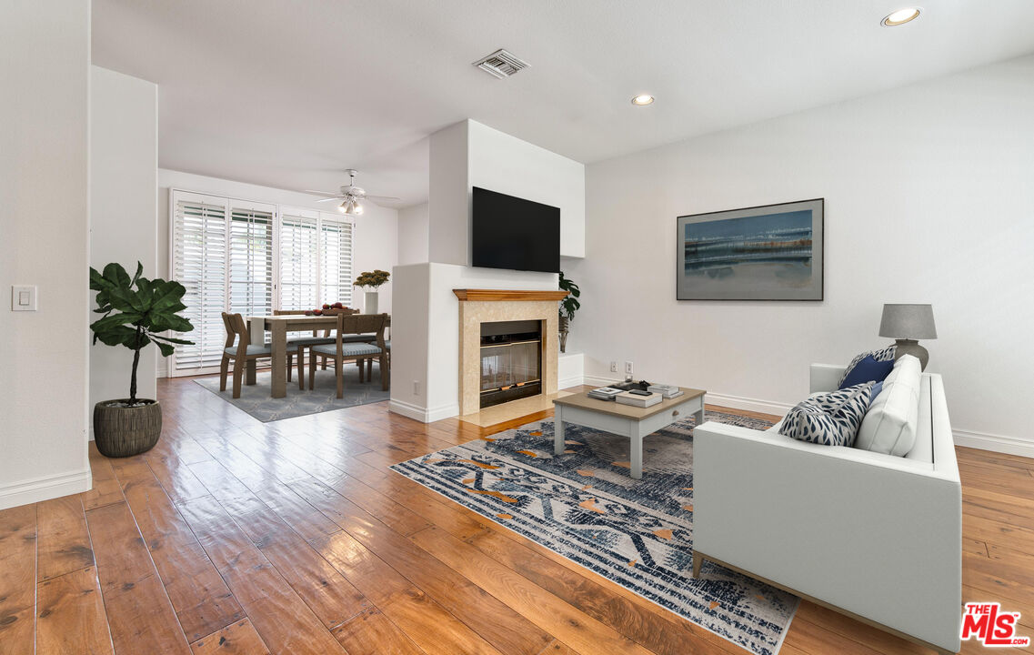 2333 Oak Street, Unit 2 Santa Monica, CA 90405 - Photo 3 of 30 a living room with furniture a flat screen tv and a fireplace