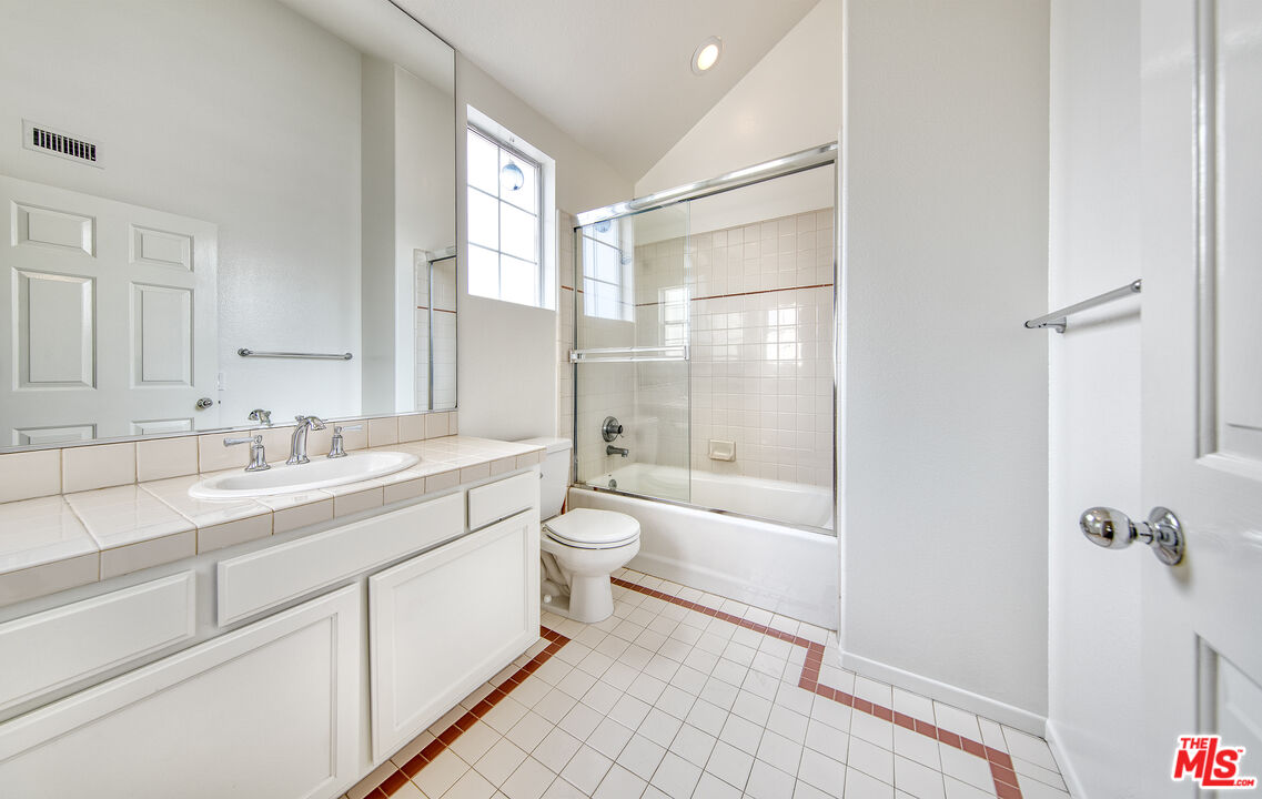 2333 Oak Street, Unit 2 Santa Monica, CA 90405 - Photo 10 of 30 a bathroom with a granite countertop sink toilet a large mirror a shower and a bathtub