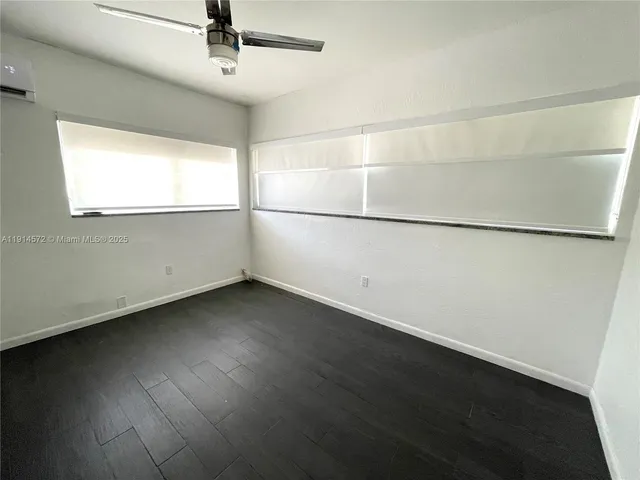 a kitchen with a wooden floor and a window