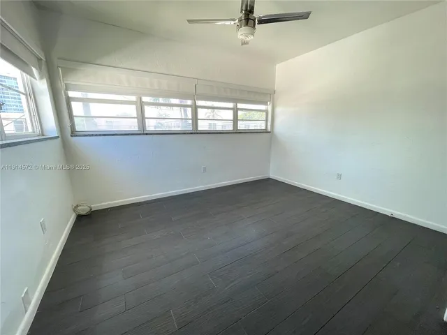 a kitchen with stainless steel appliances granite countertop a sink a stove a refrigerator and a wooden floor