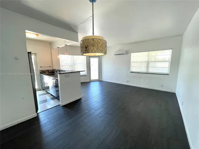 a view of a kitchen with a dishwasher cabinets and a wooden floor