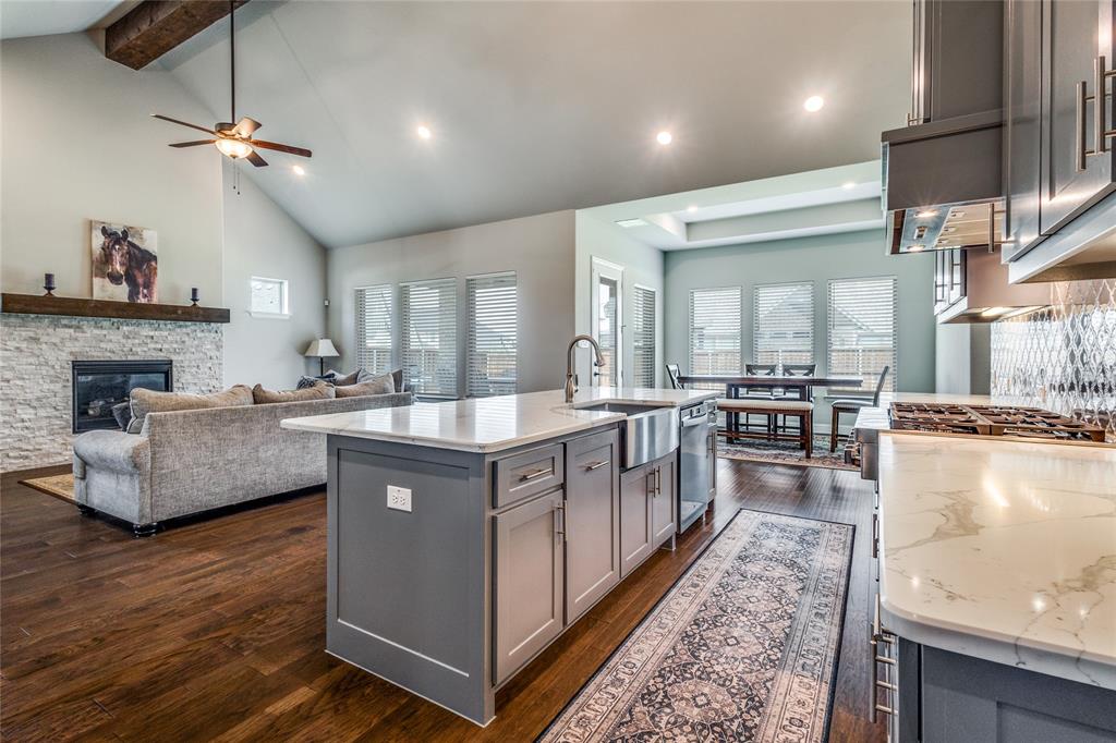 a large living room with stainless steel appliances granite countertop furniture and a kitchen view