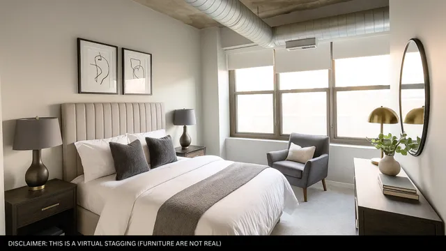 a bedroom with a bed and a large window