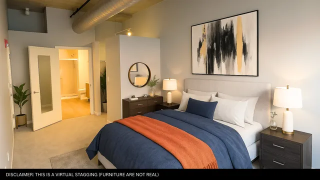 a bedroom with a bed and a painting on the wall