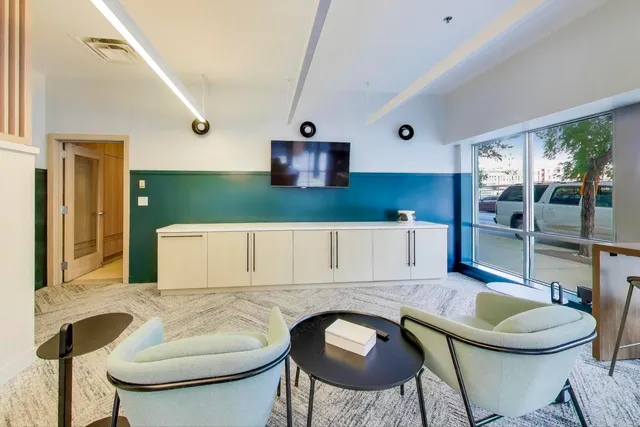 a kitchen with a table chairs stove and cabinets