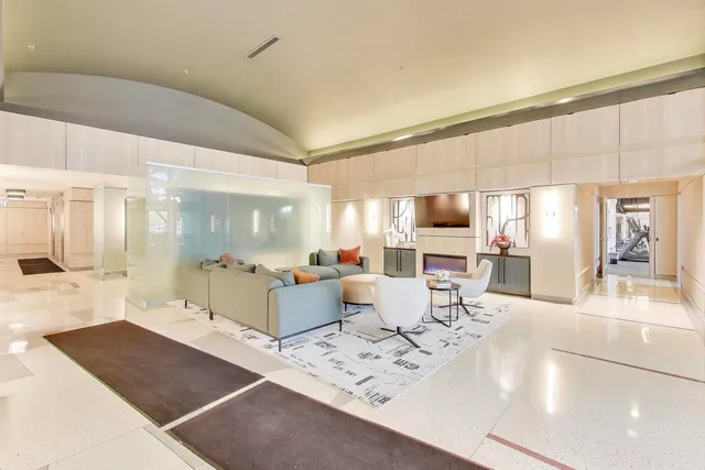 a large white kitchen with a large window and counter space