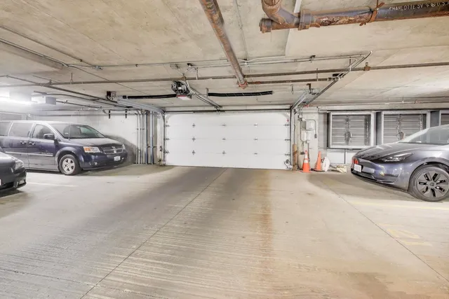 a view of parking garage with cars
