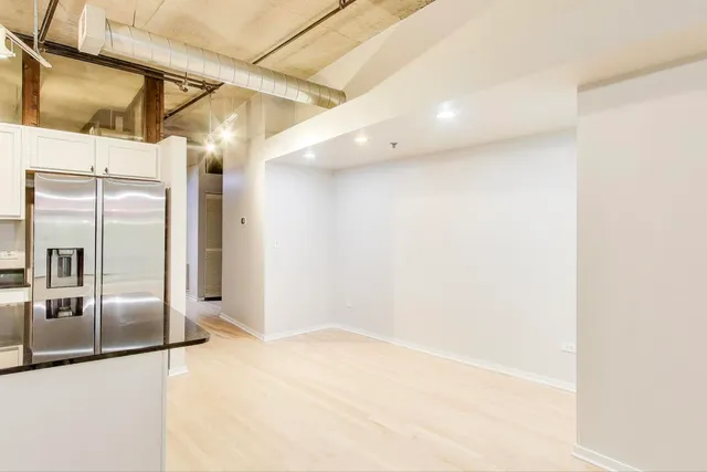a view of a refrigerator in a kitchen