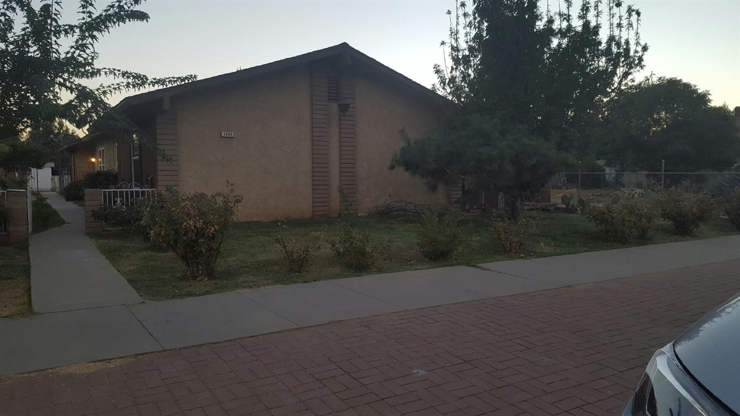 1235 C Street Reedley, CA 93654 - Photo 1 of 8 a backyard of a house with lots of green space