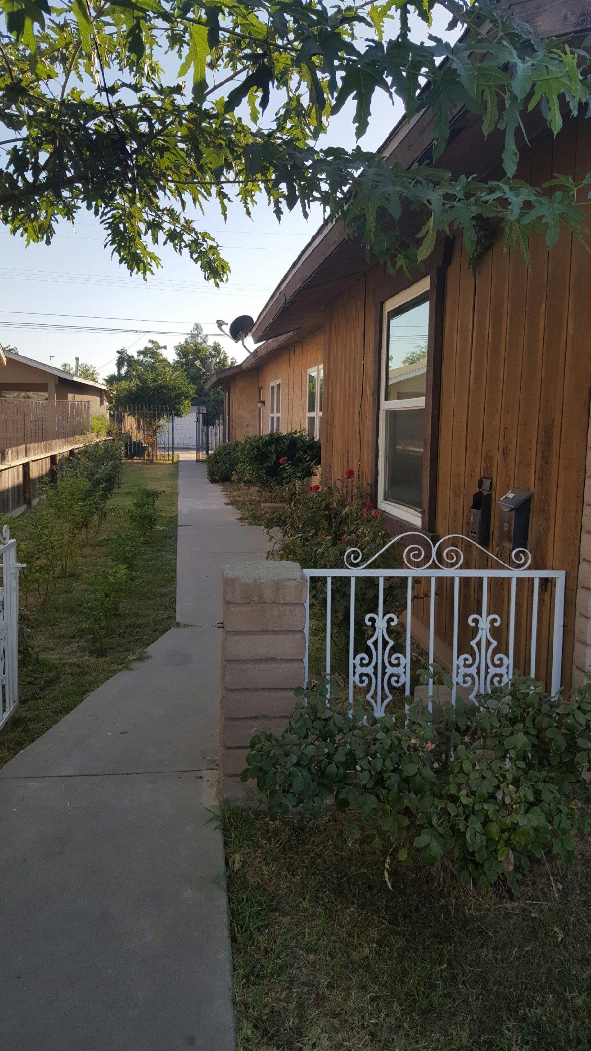 1235 C Street Reedley, CA 93654 - Photo 2 of 8 a front view of house with yard and outdoor space