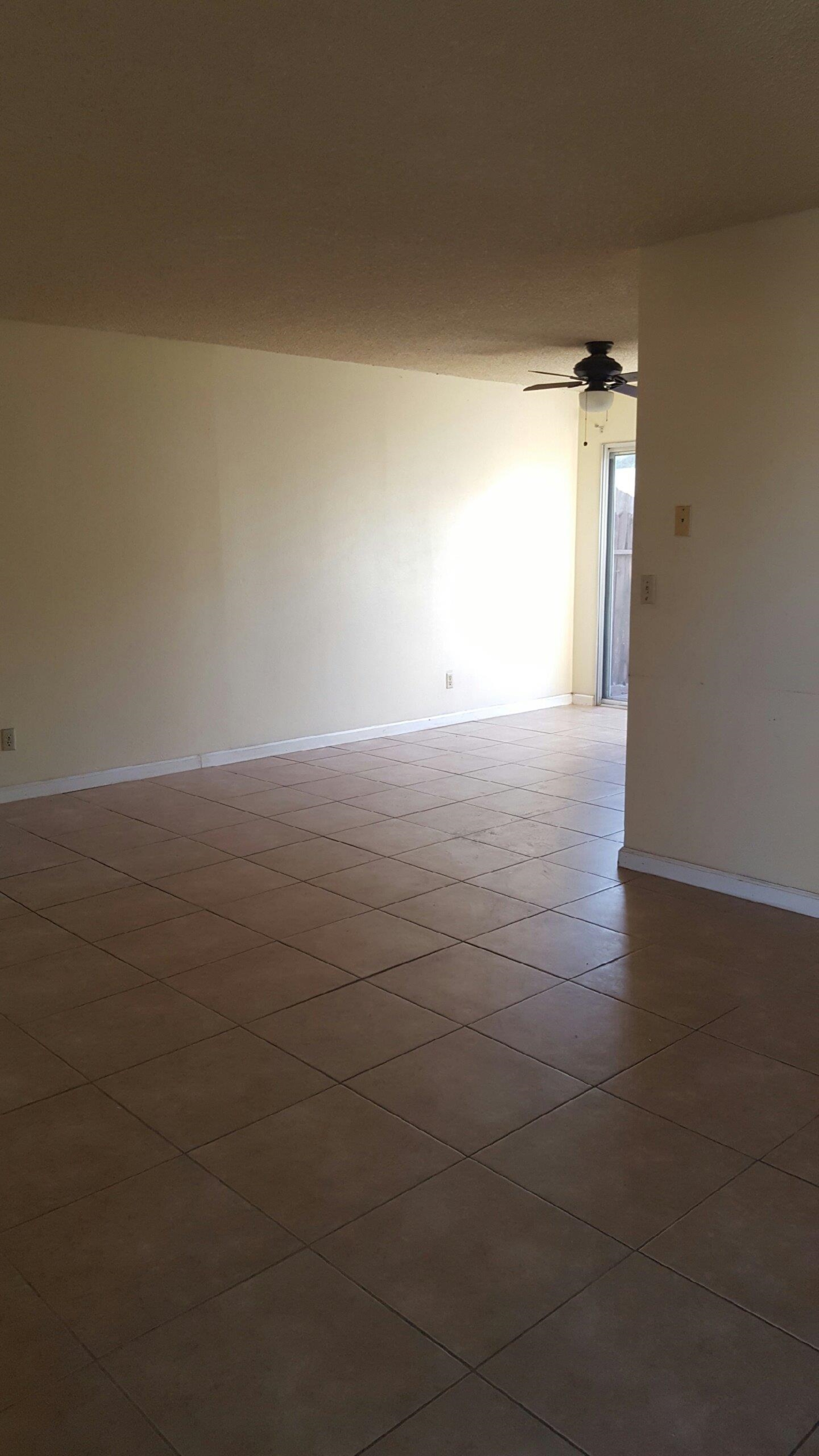 1235 C Street Reedley, CA 93654 - Photo 6 of 8 a view of an empty room and window