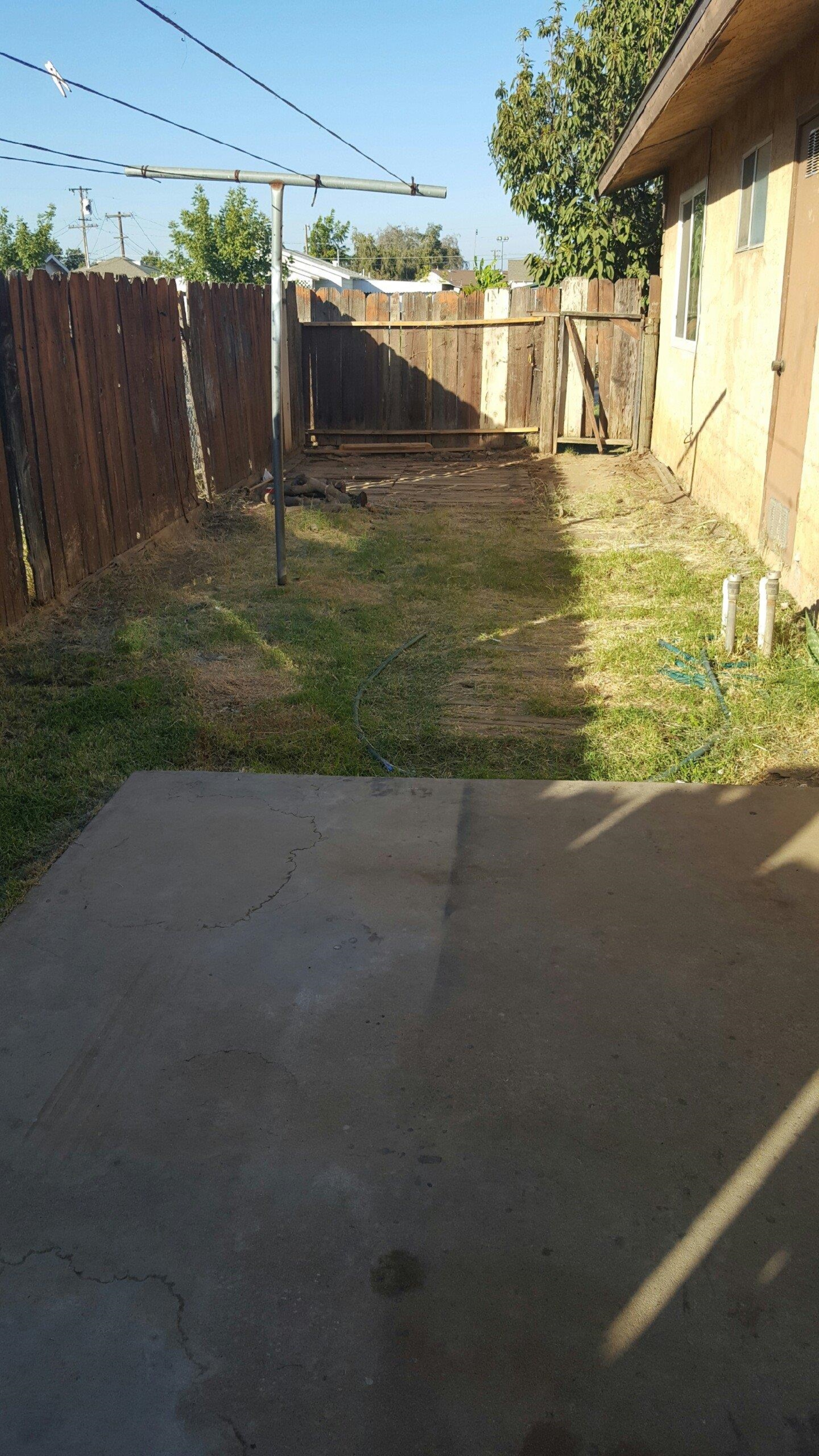 1235 C Street Reedley, CA 93654 - Photo 8 of 8 a view of a yard with wooden fence