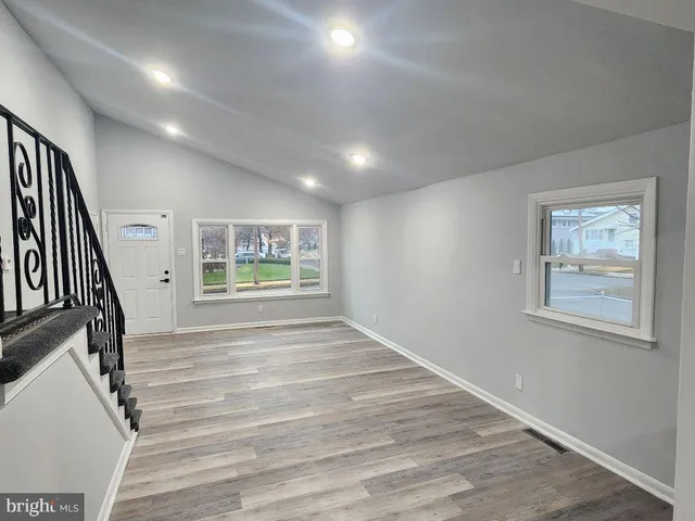 a view of an entryway with wooden floor