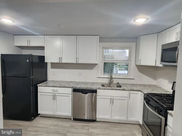 a kitchen with a sink stove and refrigerator