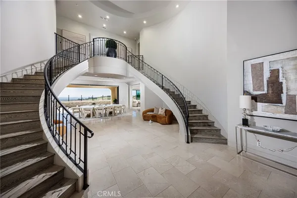 a dining room with stainless steel appliances a table and chairs