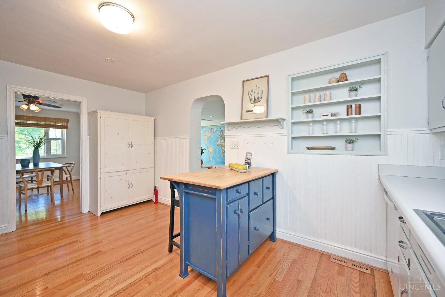 7083 Paddison Road Cincinnati, OH 45230 - Photo 24 of 78 Island and white cabinet here convey. Built is spice rack just adds to the original character of the home.