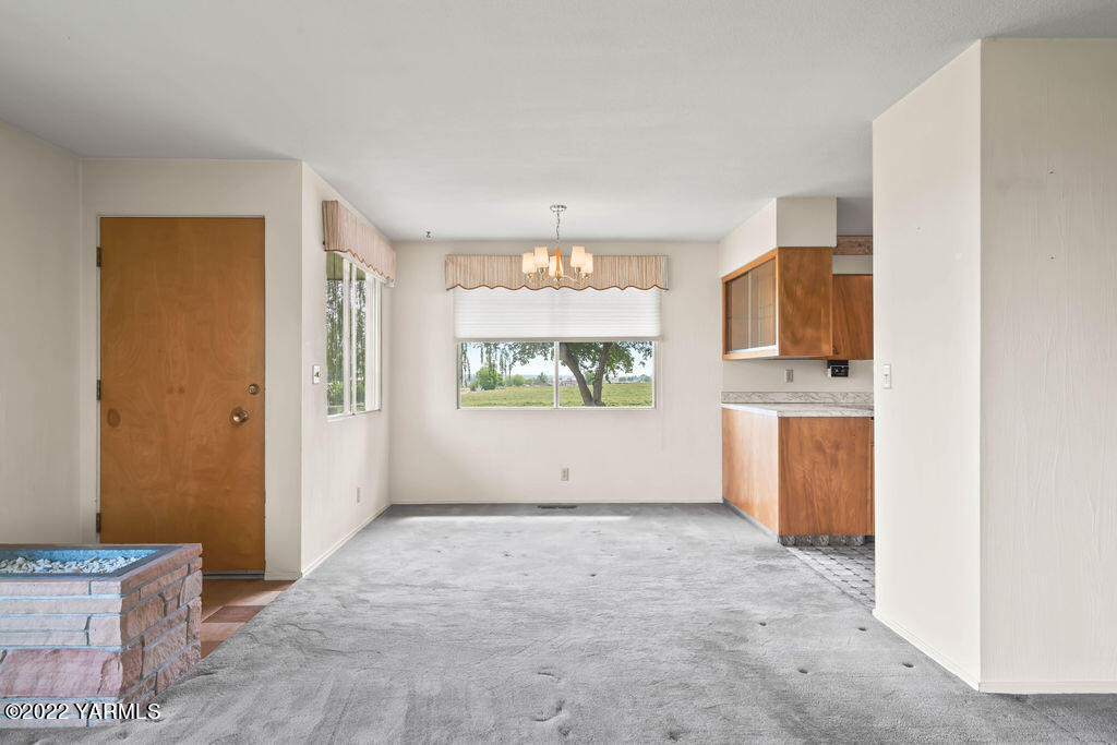 4180 Stover Road Sunnyside, WA 98944 - Photo 9 of 37 a view of an empty room with window and a kitchen