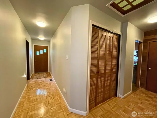 a view of a hallway with wooden floor