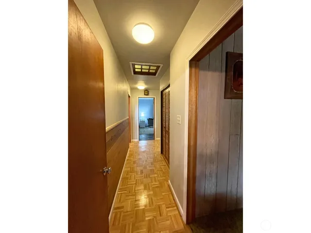 a bedroom with a bed and a view of kitchen