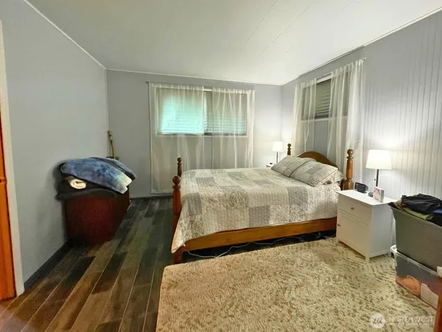 a bedroom with a bed and a television