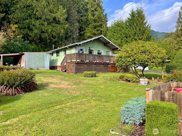 a view of a house with a yard balcony and sitting area