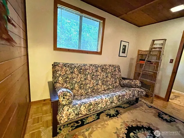 a view of a house with a big yard potted plants and large tree