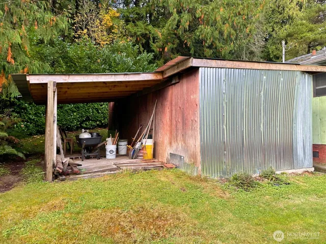 a backyard of a house with yard and outdoor seating