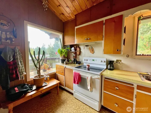 a kitchen with a stove a sink and a microwave