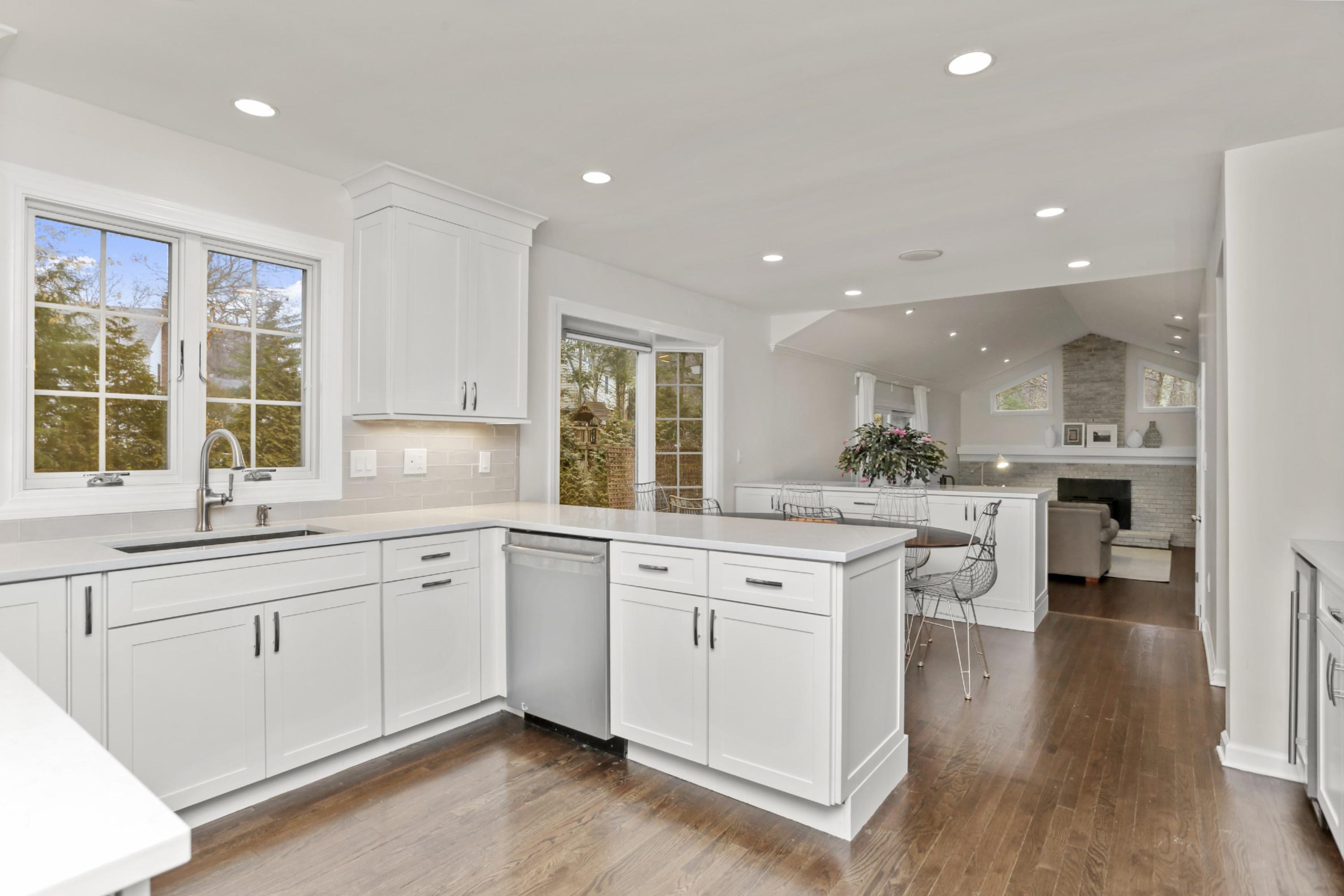 54 Country Club Road Darien, CT 06820 - Photo 11 of 40 a large kitchen with cabinets a sink a window and chairs
