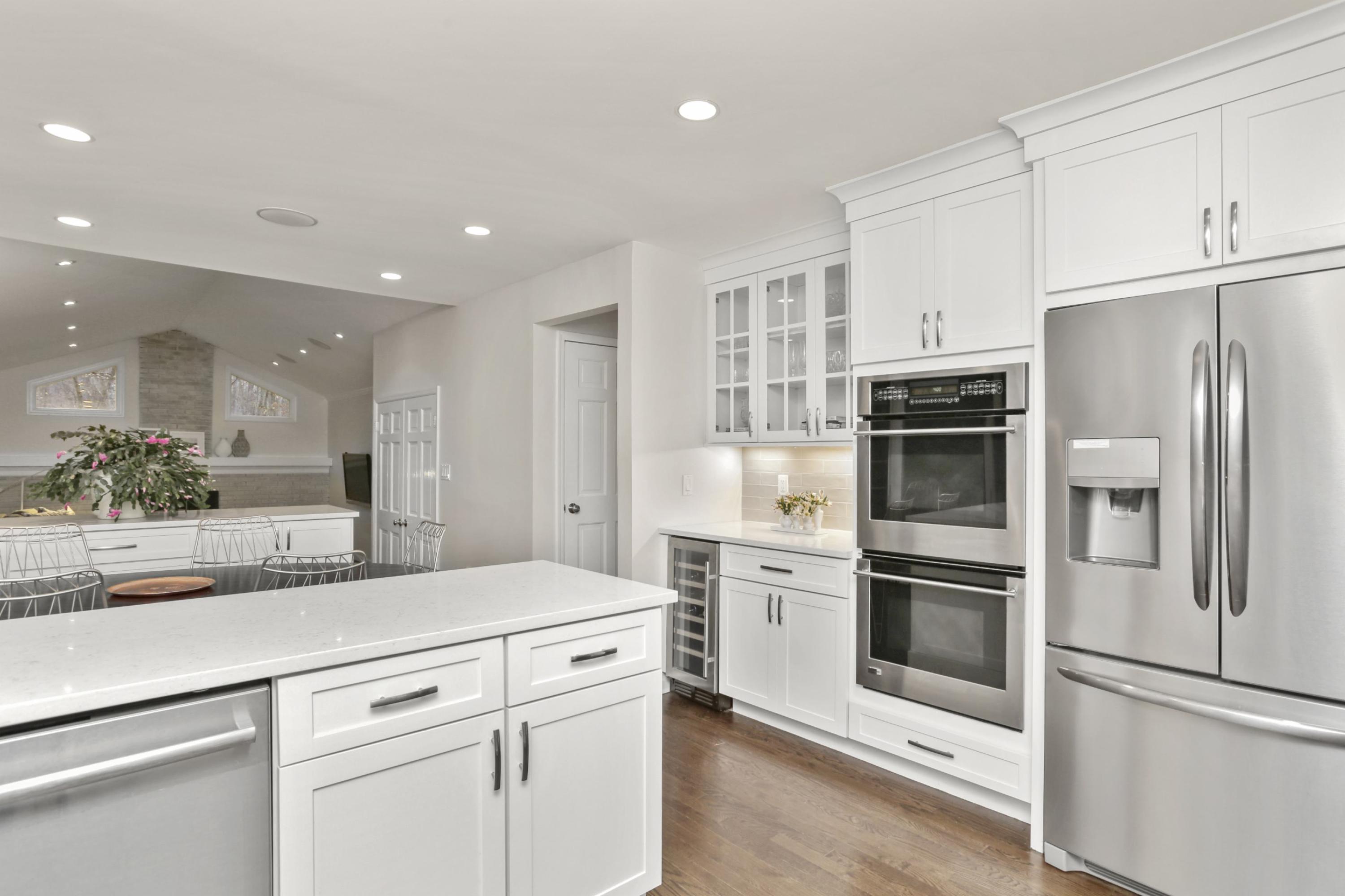 54 Country Club Road Darien, CT 06820 - Photo 15 of 40 a kitchen with stainless steel appliances and white cabinets