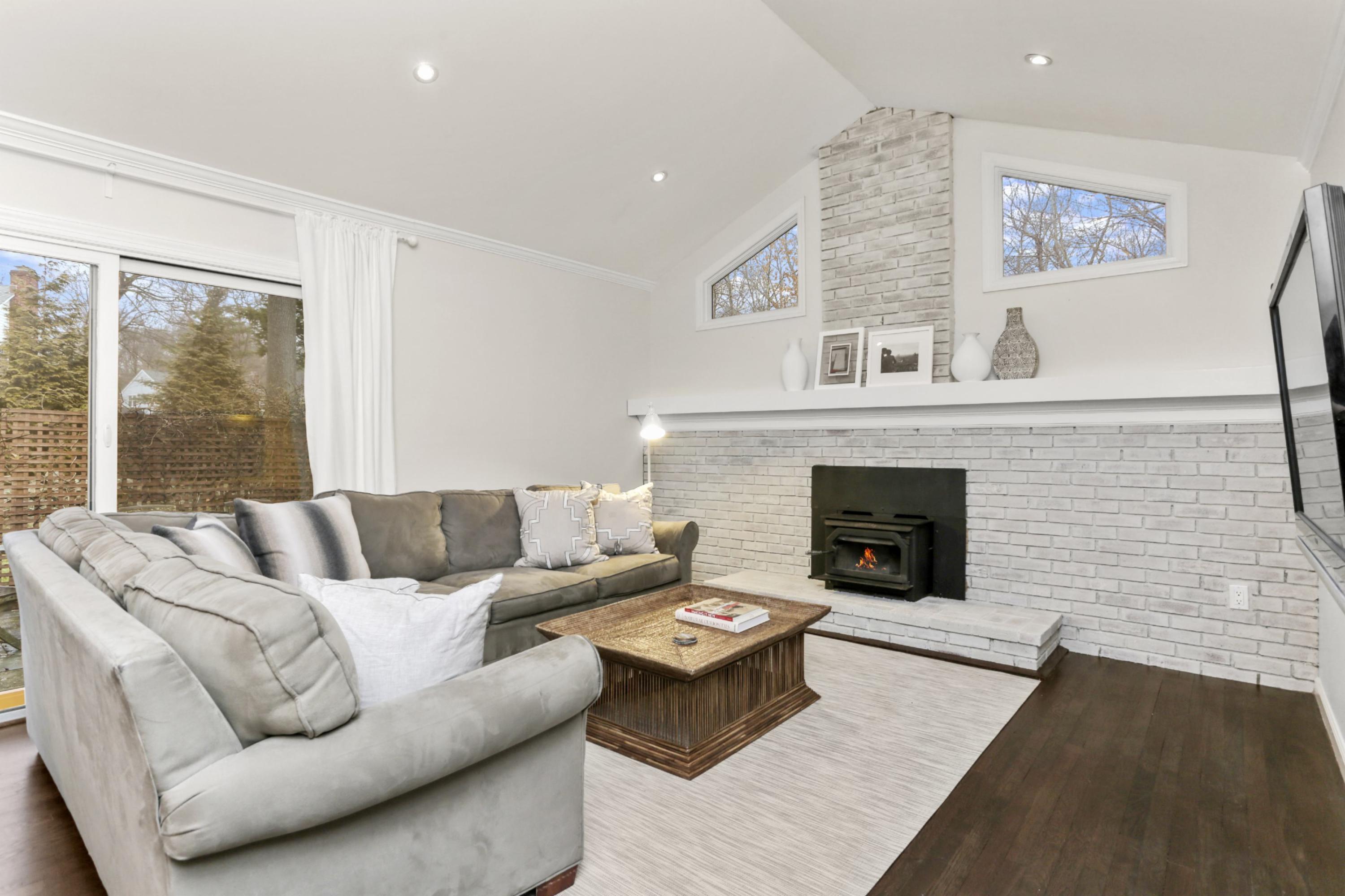 54 Country Club Road Darien, CT 06820 - Photo 16 of 40 a living room with furniture and a fireplace