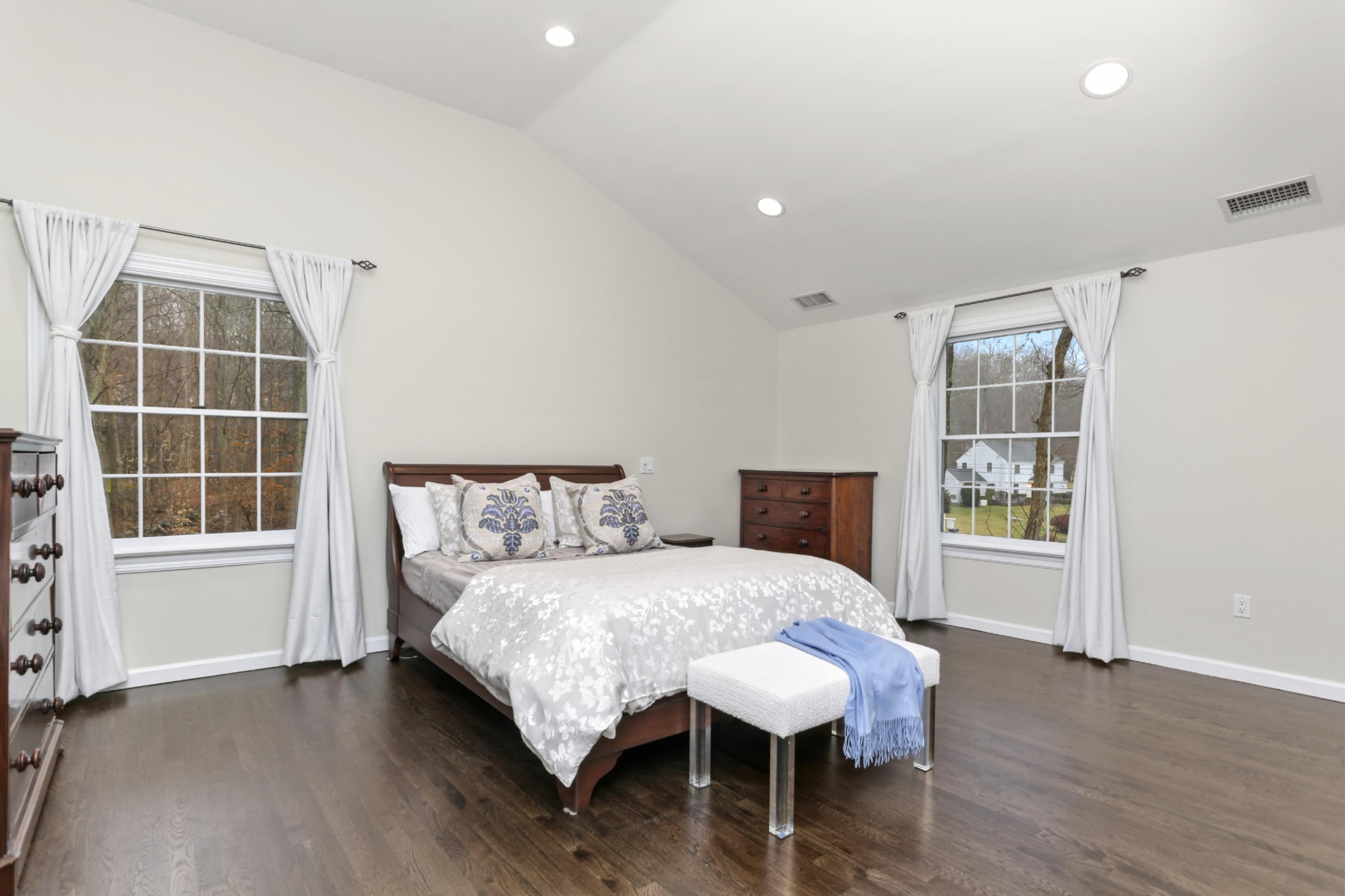 54 Country Club Road Darien, CT 06820 - Photo 19 of 40 a bedroom with a bed and wooden floor