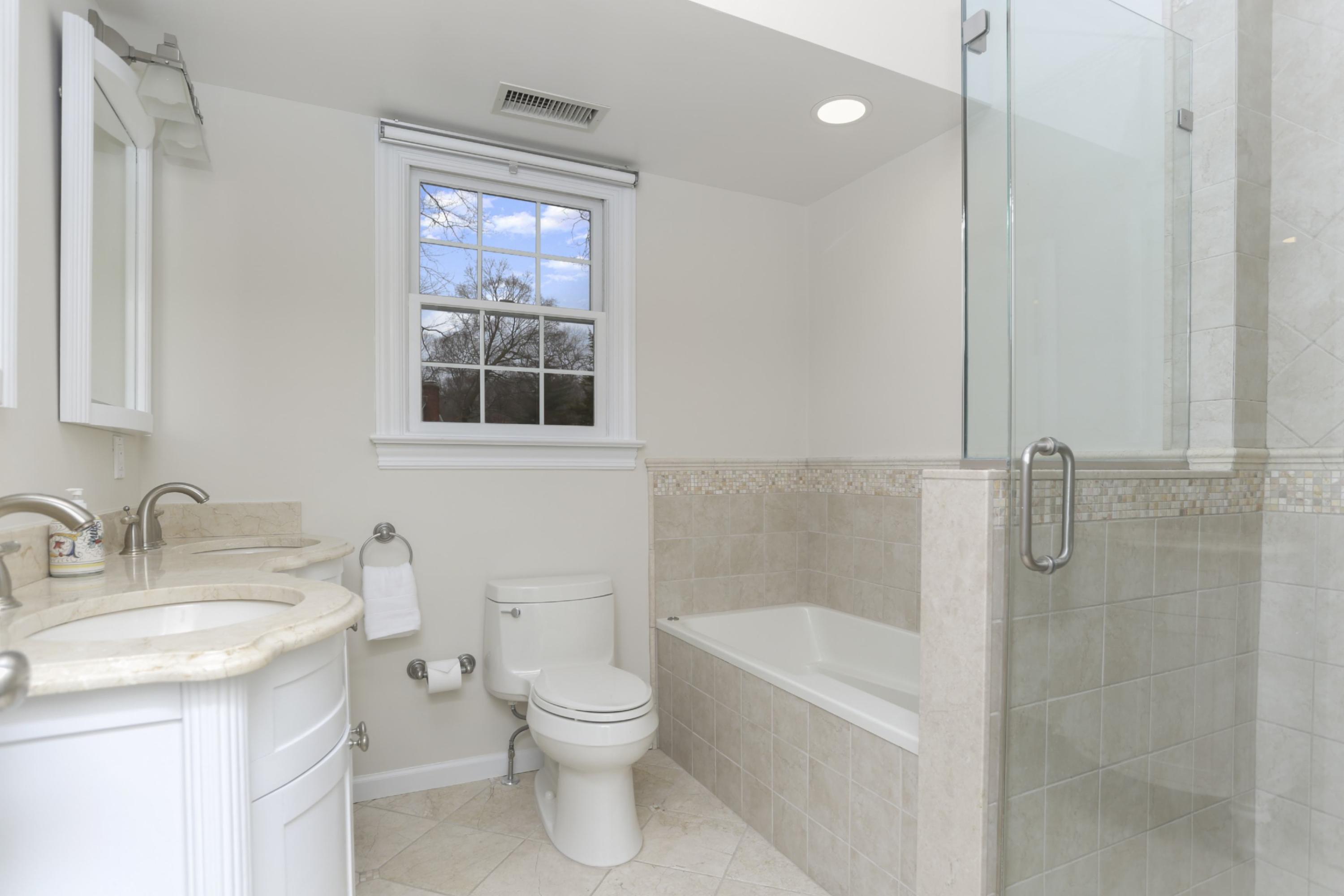 54 Country Club Road Darien, CT 06820 - Photo 22 of 40 a bathroom with a granite countertop sink a toilet and shower