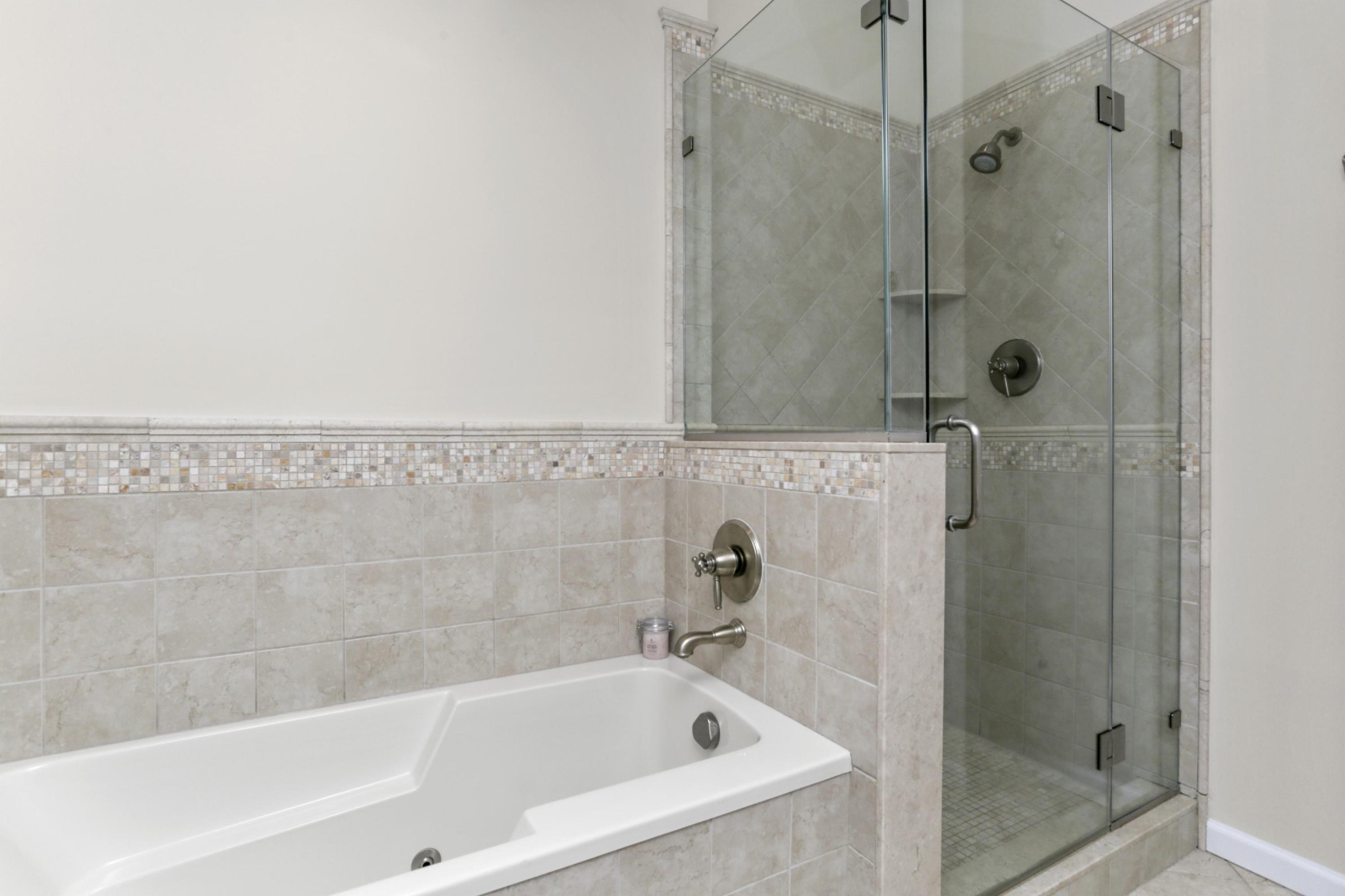 54 Country Club Road Darien, CT 06820 - Photo 23 of 40 a white bath tub sitting next to a shower