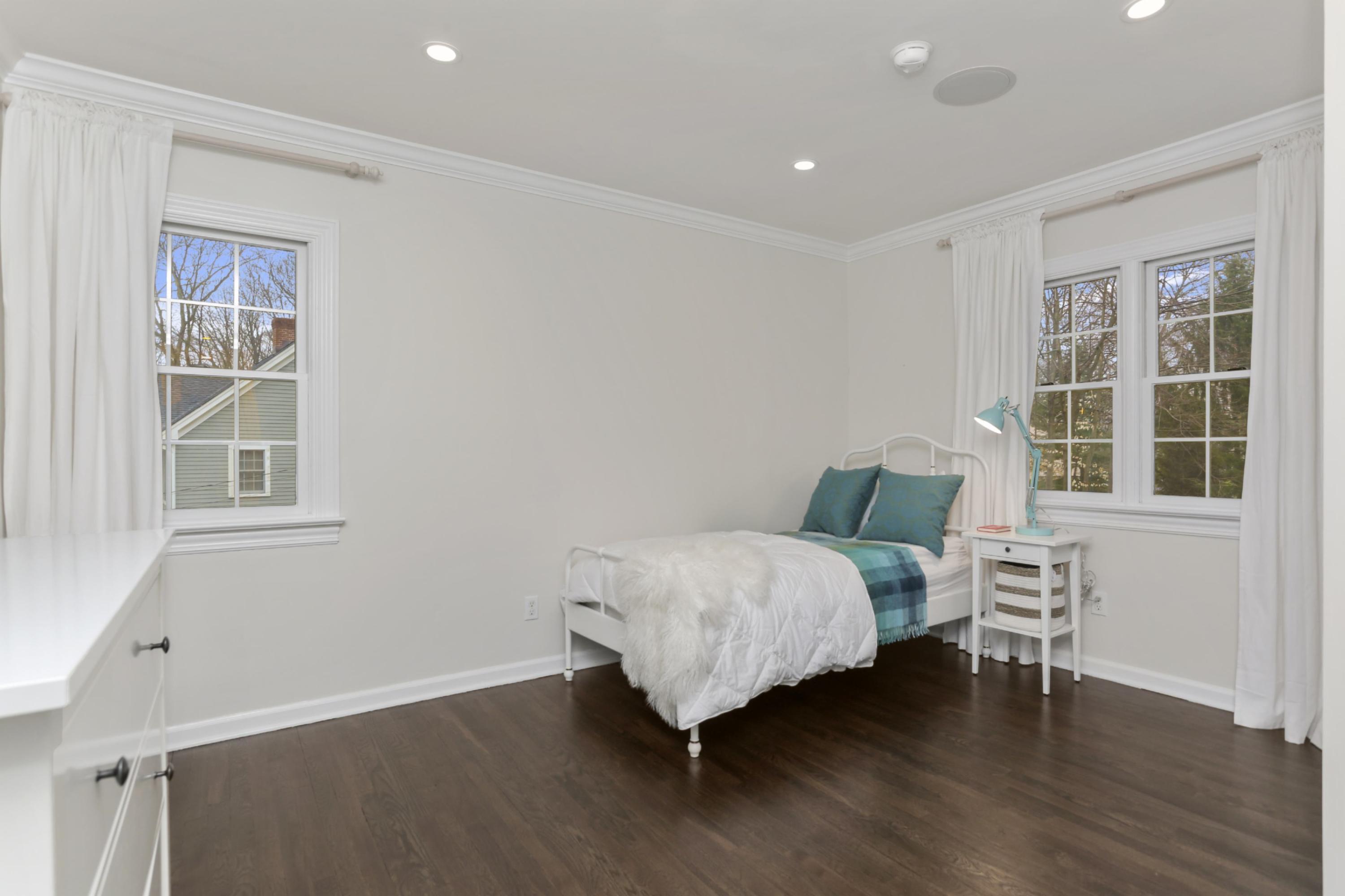 54 Country Club Road Darien, CT 06820 - Photo 27 of 40 a spacious bedroom with a bed and a window