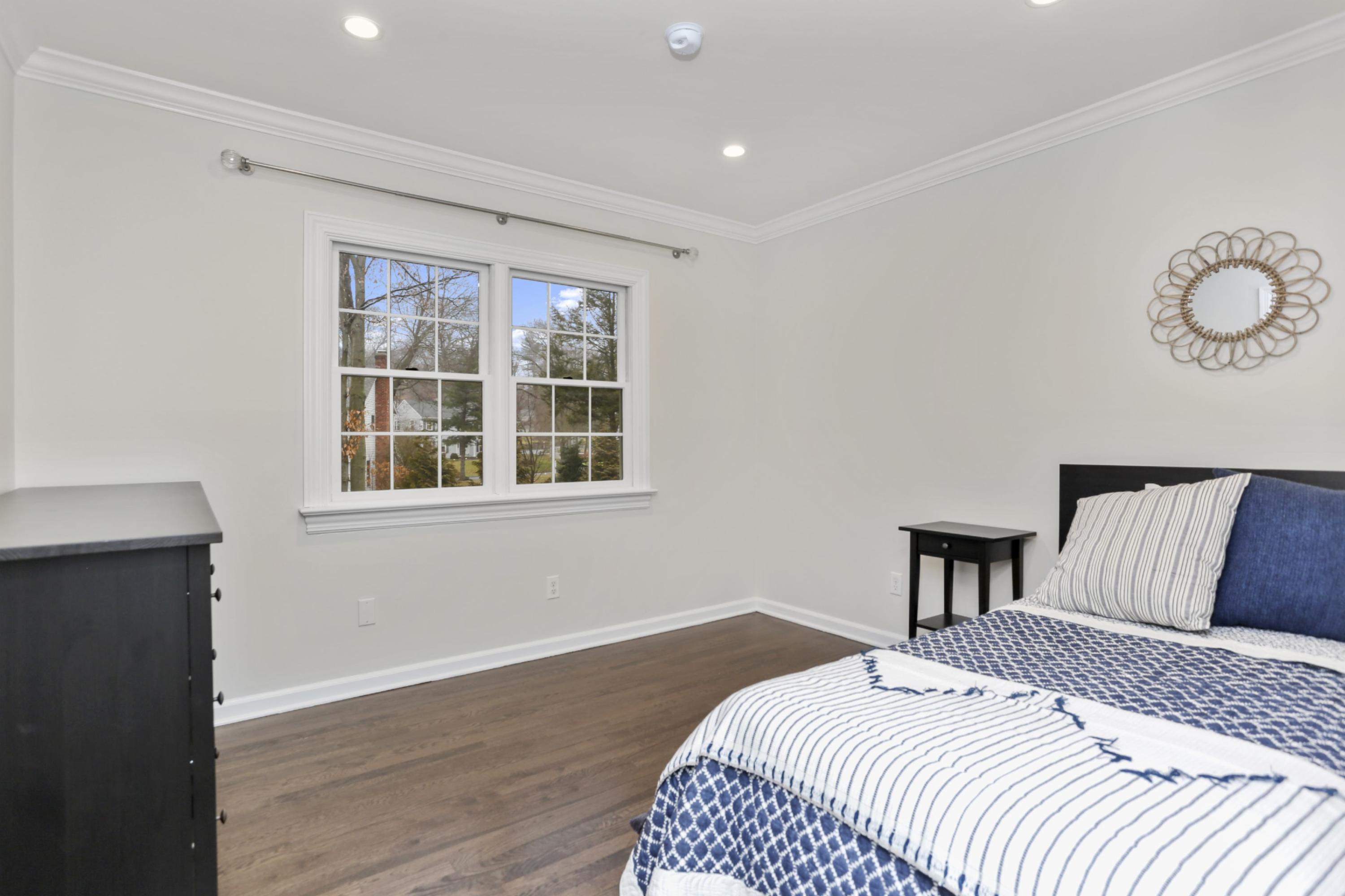 54 Country Club Road Darien, CT 06820 - Photo 28 of 40 a bedroom with a bed and wooden floor