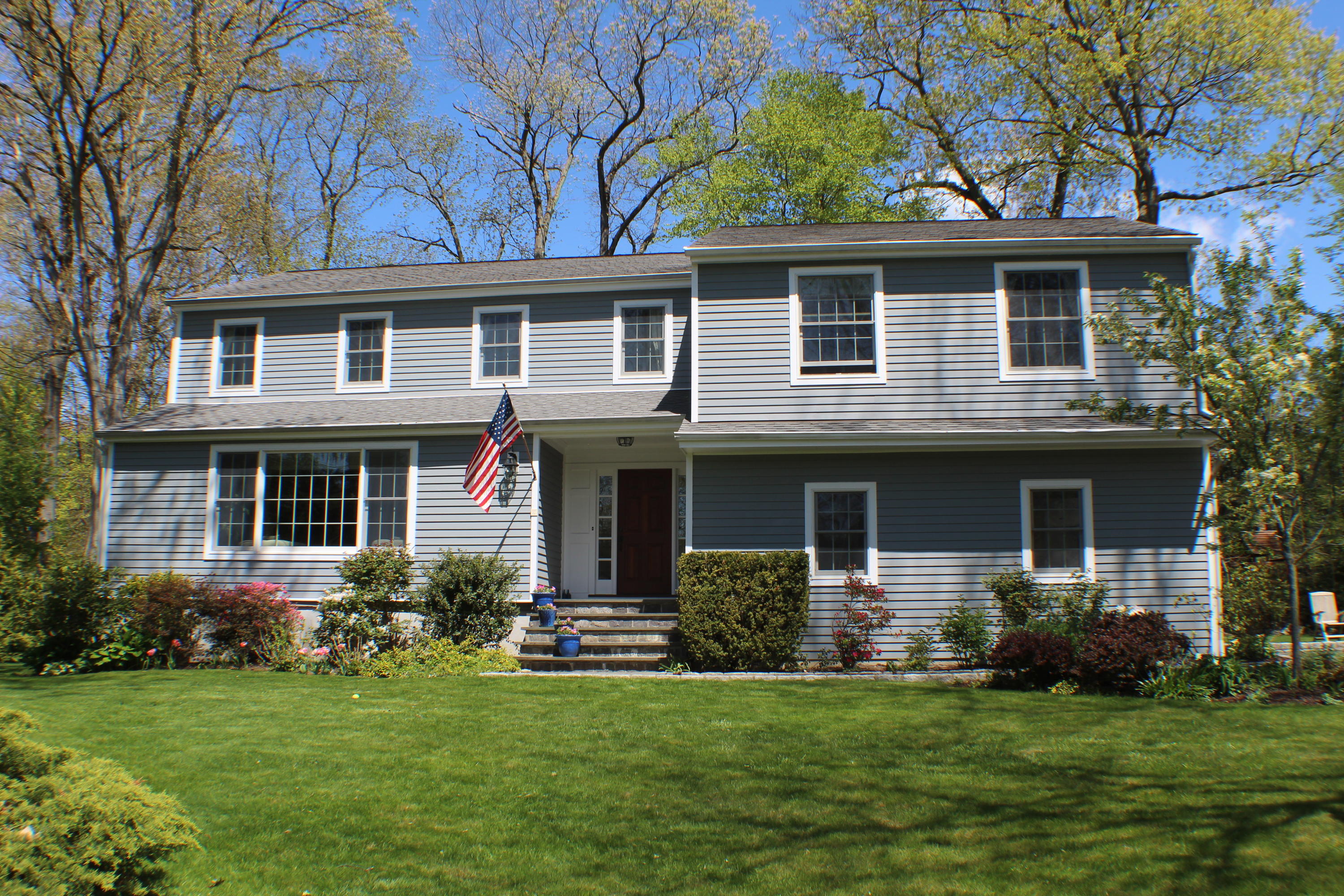 54 Country Club Road Darien, CT 06820 - Photo 3 of 40 a front view of a house with a garden