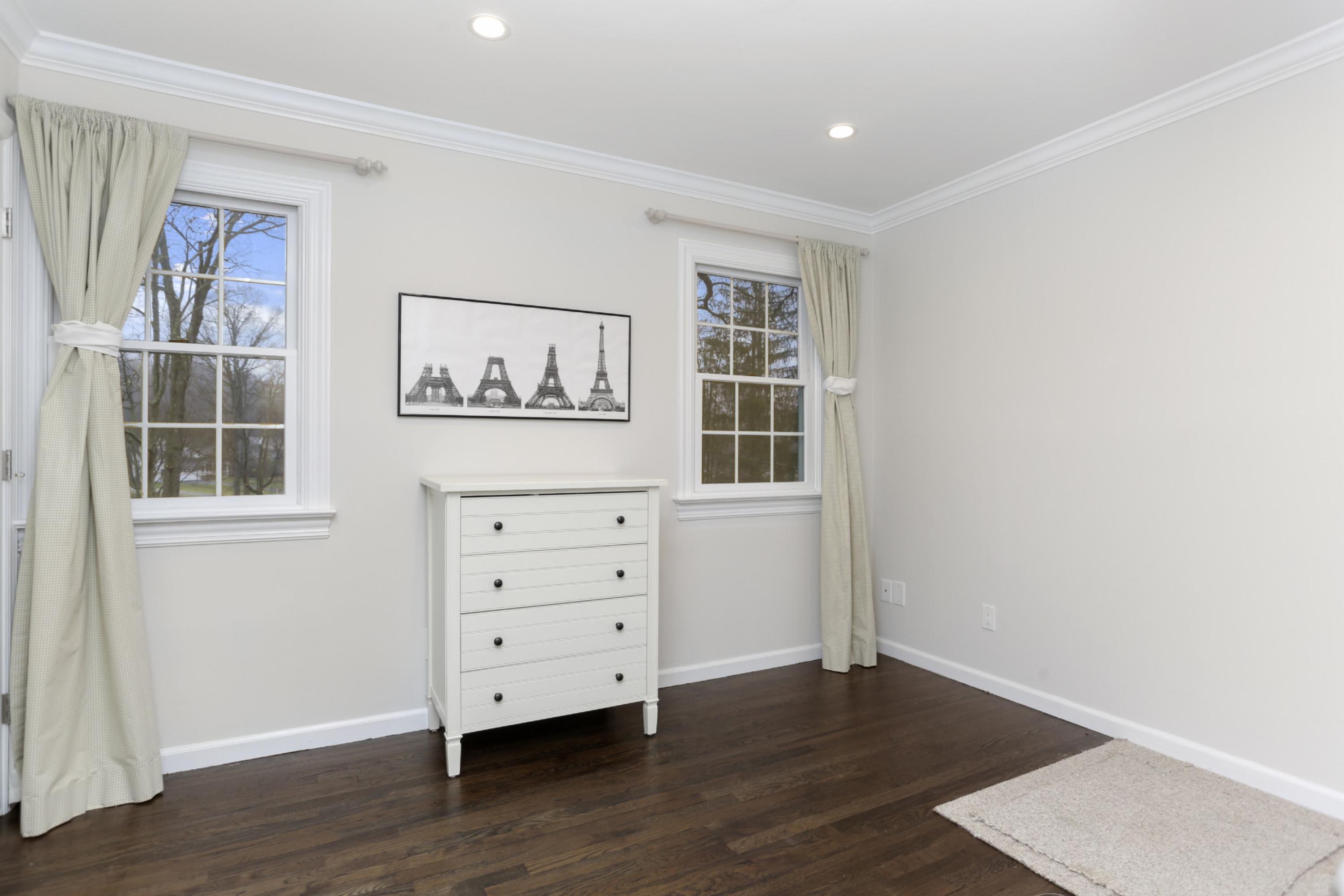 54 Country Club Road Darien, CT 06820 - Photo 30 of 40 an empty room with windows and cabinet