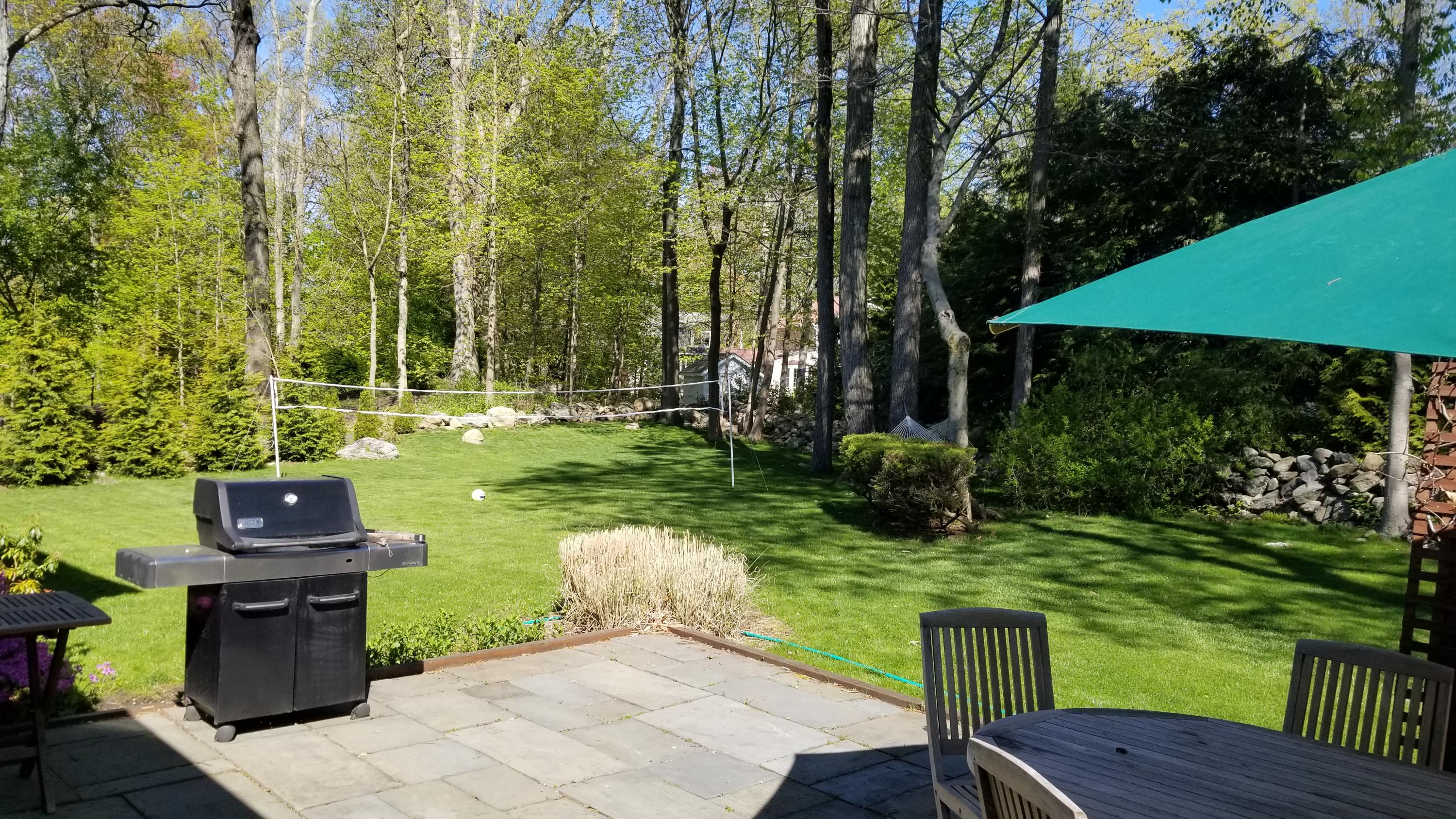 54 Country Club Road Darien, CT 06820 - Photo 34 of 40 a view of backyard with plants and outdoor seating
