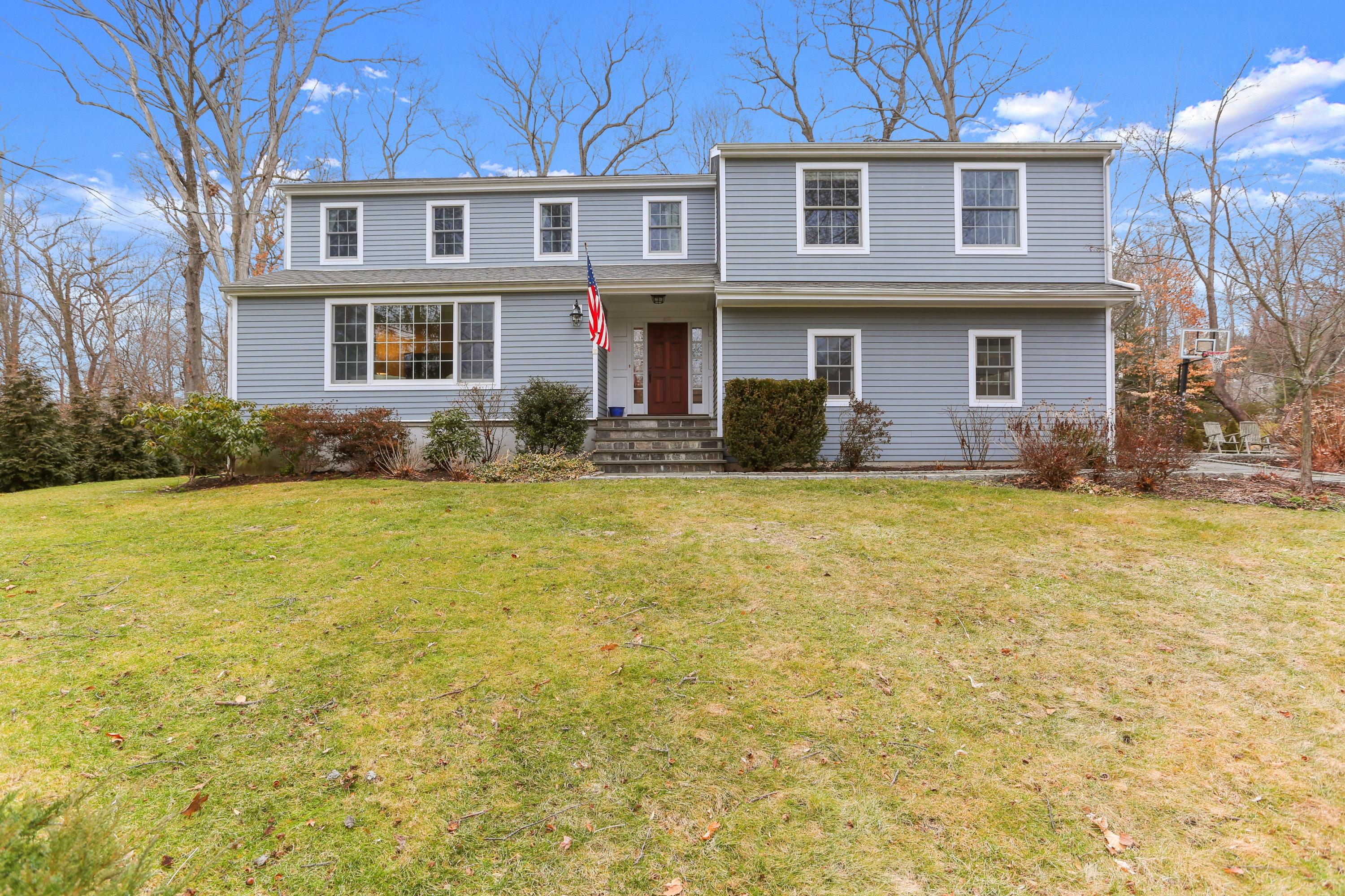 54 Country Club Road Darien, CT 06820 - Photo 36 of 40 a view of a yard in front of a brick building