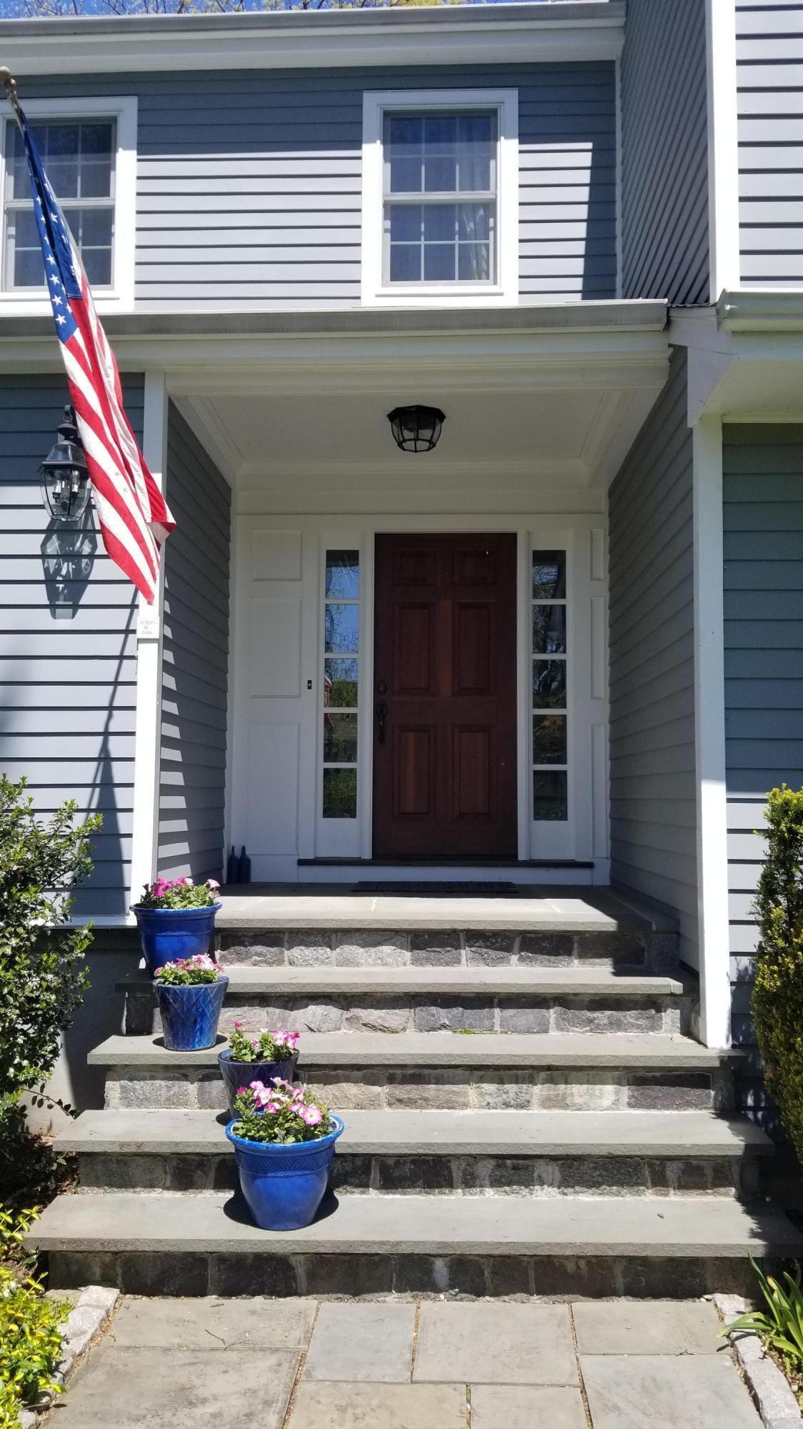 54 Country Club Road Darien, CT 06820 - Photo 4 of 40 a front view of a house with a chair