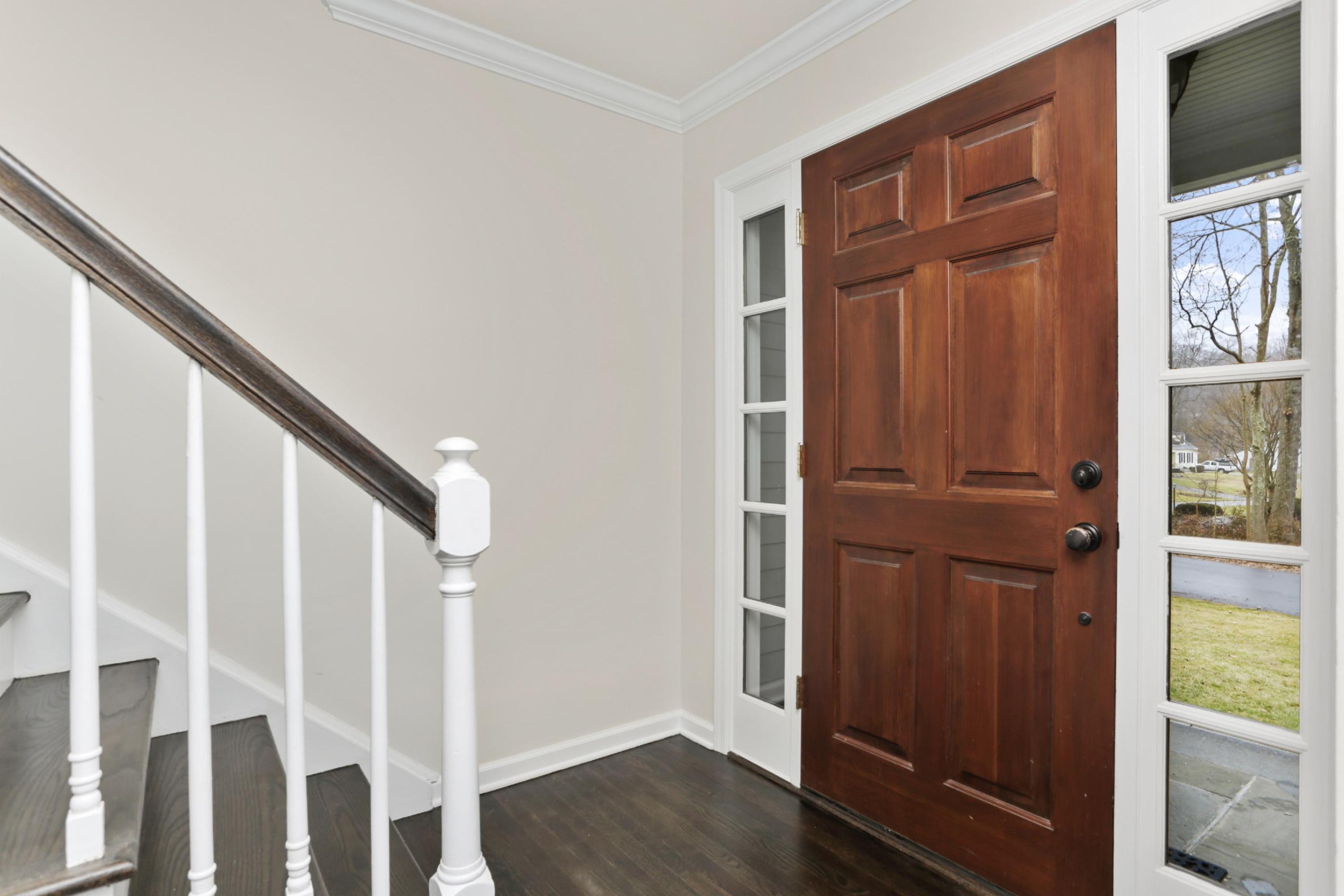 54 Country Club Road Darien, CT 06820 - Photo 5 of 40 a view of front door with wooden floor and stairs