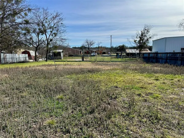 a view of swimming pool is middle in the middle of a yard