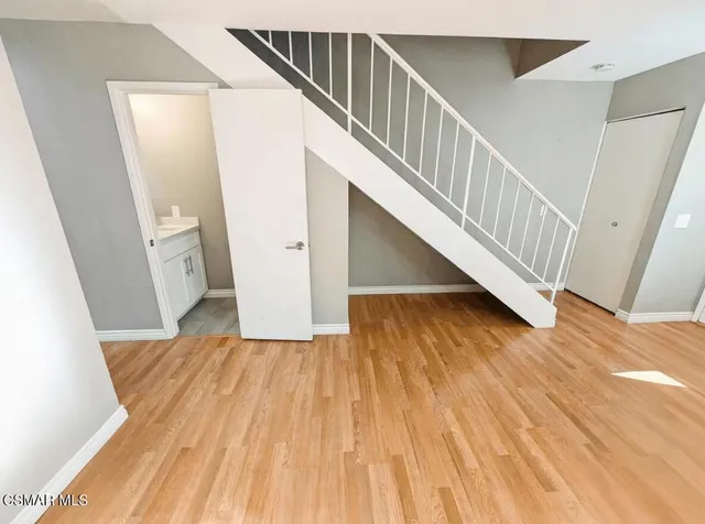 a view of entryway and hall with wooden floor
