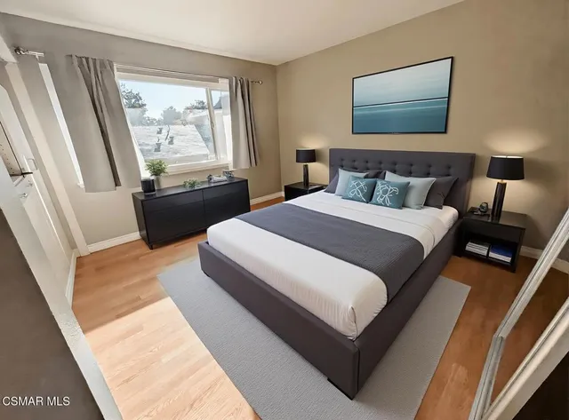 a bedroom with a bed and wooden floor