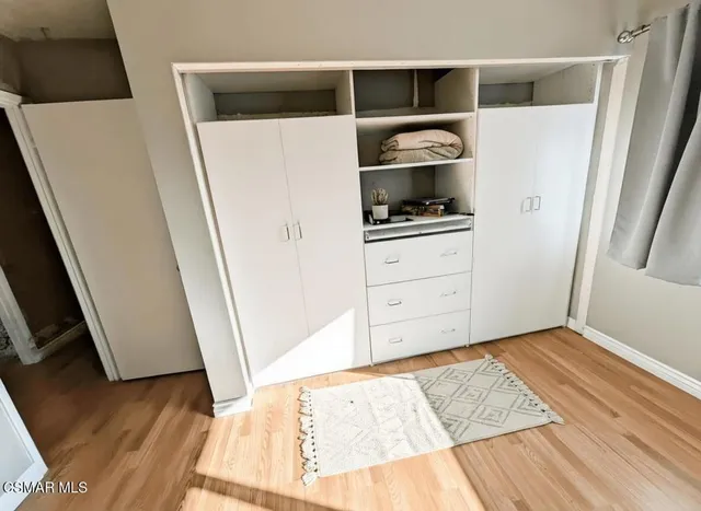a view of kitchen with wooden floor and electronic appliances